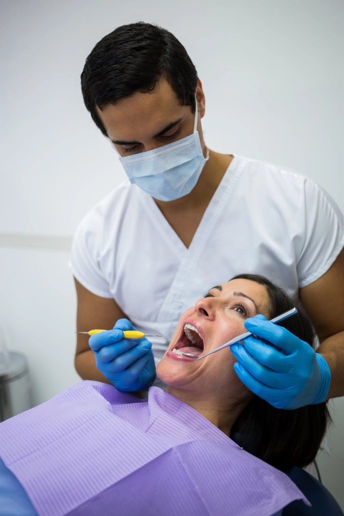 dentist-examining-female-patient-teeth