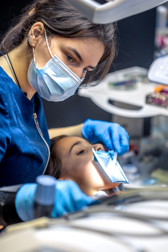 dentist-treats-childs-tooth-using-rubber-dam-closeup-tooth-treatment
