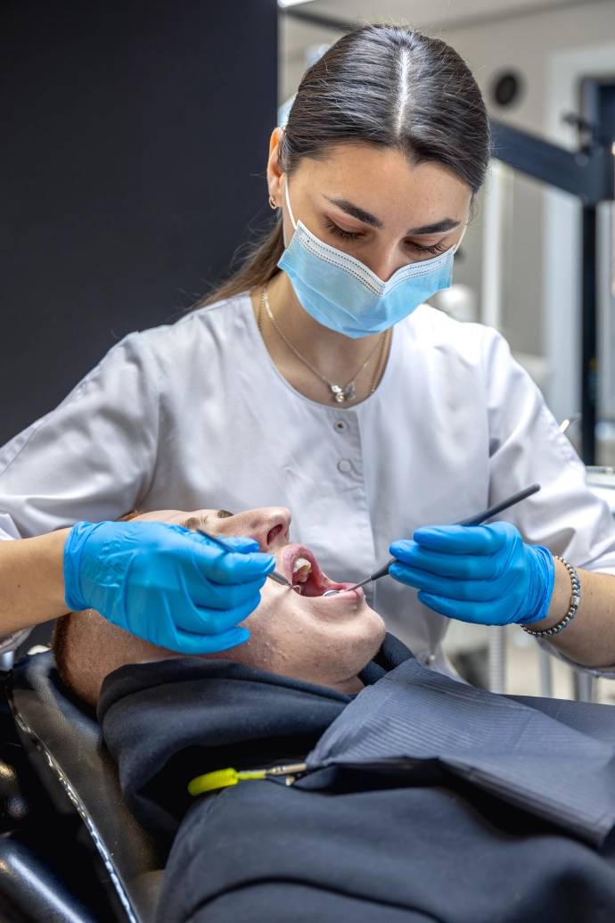female-dentist-treats-patients-teeth-stomatologist-working-with-professional-equipment